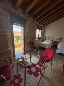a room with a table and chairs in a room at El Jardín de los Olivos in Fuentesaúco de Fuentidueña