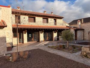 an exterior view of a building with a courtyard at El Jardín de los Olivos in Fuentesaúco de Fuentidueña