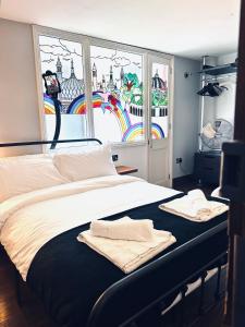 a bedroom with a bed with towels on it at Guest And The City in Brighton & Hove