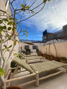 a patio with two benches on top of a building at Hotel & Riad Celia in Marrakesh