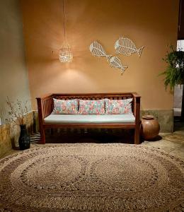 a bench in a room with a wall with fish on it at Villa Wiktor Paracuru in Paracuru +44 photos