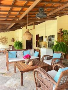 a patio with a couch and a table at Villa Wiktor Paracuru in Paracuru