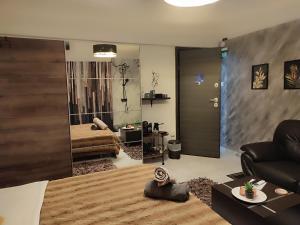 a living room with a bed and a mirror at ViP in Veria