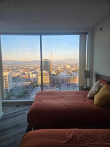 a bed in a room with a large window at 2 Bedroom with City Views in Los Angeles