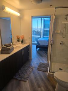 a bathroom with a shower and a sink and a toilet at 2 Bedroom with City Views in Los Angeles