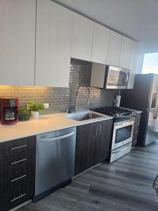 a kitchen with a sink and a stove at 2 Bedroom with City Views in Los Angeles +13 photos