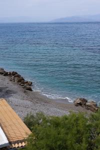 a view of the ocean with a sandy beach at Myrto's Memories "My Sofitaki"- Seaview Studio in Melíssion