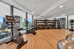 a gym with treadmills and exercise equipment in a building at Gorgeous 3BR Apartment with Study overlooking BNE River in Brisbane