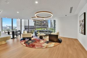a living room with a couch and a table at Gorgeous 3BR Apartment with Study overlooking BNE River in Brisbane