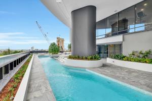 a swimming pool on the side of a building at Gorgeous 3BR Apartment with Study overlooking BNE River in Brisbane
