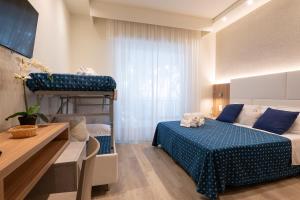 a bedroom with a bed and a bunk bed at Hotel Reggiana in Riccione +52 photos