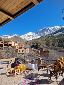 a patio with a view of a snowy mountain at Dar Benhoussa Imlil in Imlil