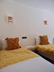 two beds sitting next to each other in a room at Dar Benhoussa Imlil in Imlil