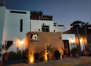 a building with a sign on the side of it at Casa Aceves & Bueno Hotel Boutique in El Salto