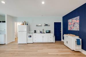 a kitchen with white appliances and blue walls at Ranchette Apartment- beach access small lake view in Buchanan Dam