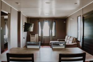 a living room with a table and chairs and a couch at Cabañas Lihuen in Caviahue