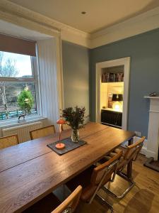 a dining room with a wooden table and chairs at The Cruachan Stoer in Stoer