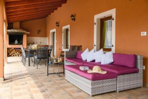 a living room with a purple couch and a table at Villa Percan - Spacious Family Home with Private Pool on a 4000 Square Meter Plot in Krnica