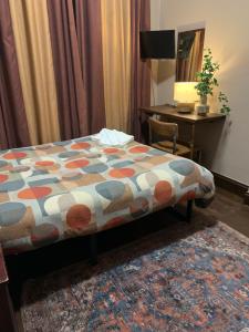 a bedroom with a bed and a desk with a computer at Four Stars Hotel in London