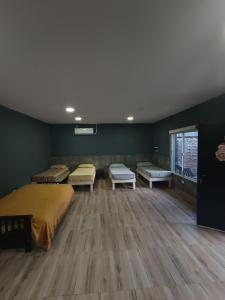 a room with a bed and benches in it at Residencia Dos Soles 2.0 in Resistencia +6 photos
