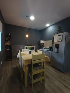 a kitchen with a table and a refrigerator at Residencia Dos Soles 2.0 in Resistencia