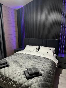a bedroom with a large bed with purple lights at Gora vitriv in Slavske