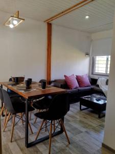 a living room with a table and a couch at Casa Uno in Paso de la Patria