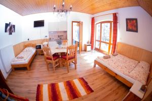 a living room with a table and a dining room at Vicze Apartmanház in Siófok