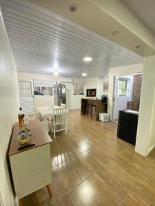 a kitchen and living room with a table and chairs at Casa central in Rosário do Sul