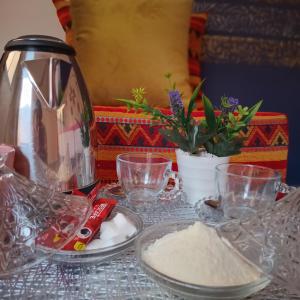 a table topped with glass dishes and a bowl of flour at Dar Benhoussa Imlil in Imlil