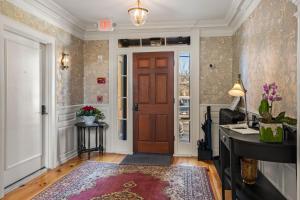 a hallway with a wooden door and a desk at The Davenport Inn in Portsmouth