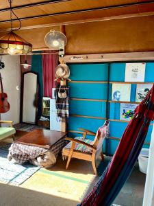 a room with a hammock and a blue wall at YAMABE BOSSA inn in Matsumoto +56 photos
