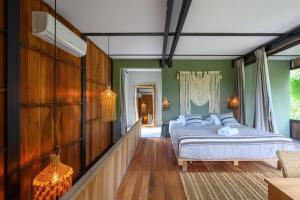 a bedroom with a bed and green walls at Vida Silvestre Tulum in Tulum +51 photos