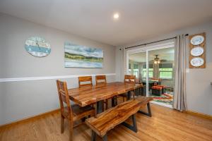 a dining room with a wooden table and chairs at On Deep Creek Time by Railey Vacations in Friendsville
