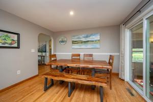 a dining room with a wooden table and chairs at On Deep Creek Time by Railey Vacations in Friendsville