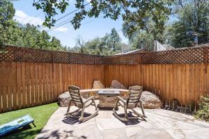 a patio with two chairs and a table in front of a fence at Timberland Hideaway in Payson +27 photos