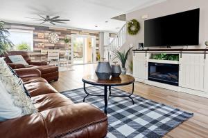 a living room with a couch and a table and a tv at Superstition Sunrise in Gold Canyon