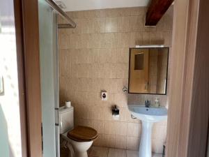 a bathroom with a sink and a toilet and a mirror at Byron in Zlaté Moravce