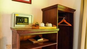 a wooden cabinet with a microwave and a telephone at Kelimutu Crater Lakes Ecolodge in Kelimutu
