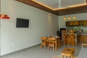 a living room with a table and some chairs at Wanasari Villa in Tampaksiring
