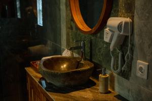 a bathroom with a bowl sink and a hair dryer at Wanasari Villa in Tampaksiring +29 photos