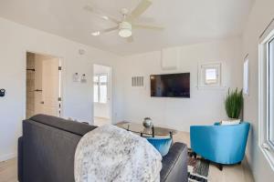 a living room with a couch and a table at Cosmopolitan Cottage in Phoenix