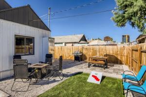 a backyard with a ping pong table and chairs at Cosmopolitan Cottage in Phoenix