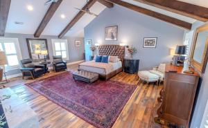 a large living room with a bed and a couch at Whispering Prairie Lodge in Salina +21 photos
