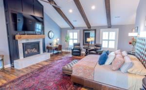 a living room with a bed and a fireplace at Whispering Prairie Lodge in Salina
