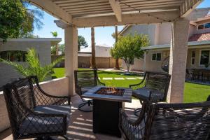 a patio with chairs and a table with a fire pit at The Seaside Bohemian in Chandler