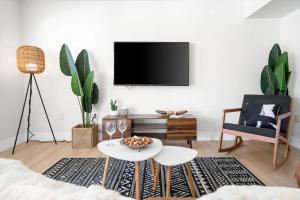 a living room with a tv on a wall at The Seaside Bohemian in Chandler