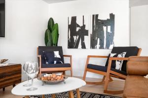 a living room with two chairs and a table at The Seaside Bohemian in Chandler +43 photos
