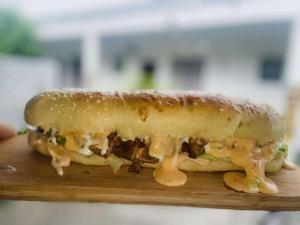 a sandwich sitting on top of a wooden board at Simon's Place in Nuku‘alofa