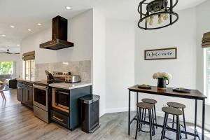 a kitchen with an island with a stove and stools at DL882 - Desert Falls Poolside Escape - Alice Lodging in Palm Desert